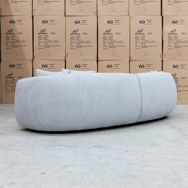 The Trenton Curved Boucle Four Seater - Light Grey available to purchase from Warehouse Furniture Clearance at our next sale event.