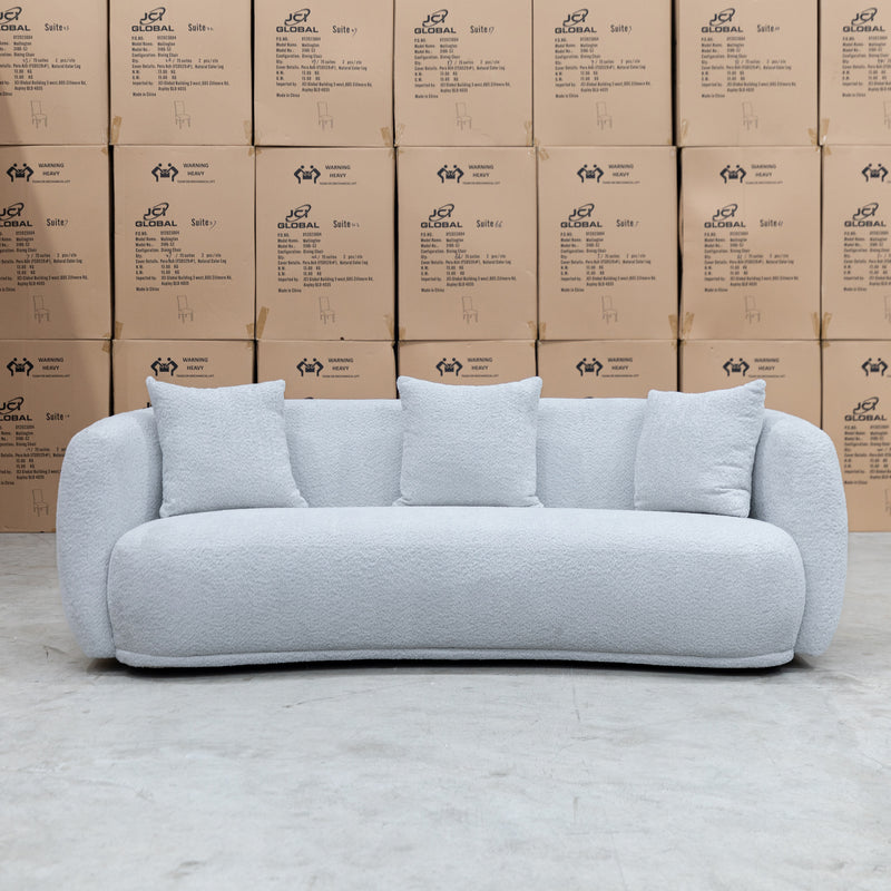 The Trenton Curved Boucle Three Seater - Light Grey available to purchase from Warehouse Furniture Clearance at our next sale event.