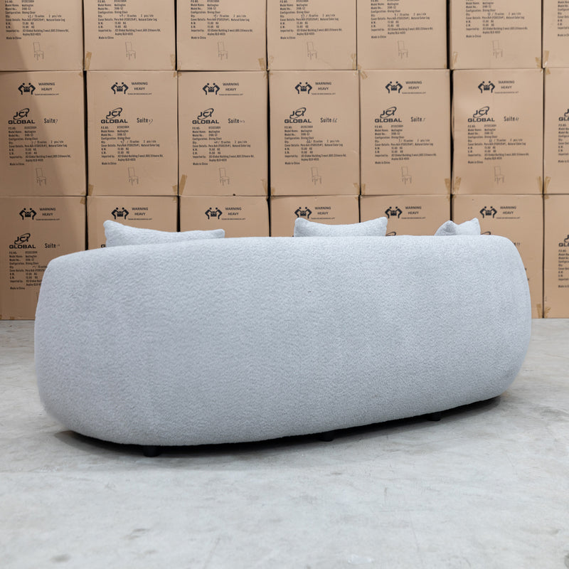 The Trenton Curved Boucle Three Seater - Light Grey available to purchase from Warehouse Furniture Clearance at our next sale event.