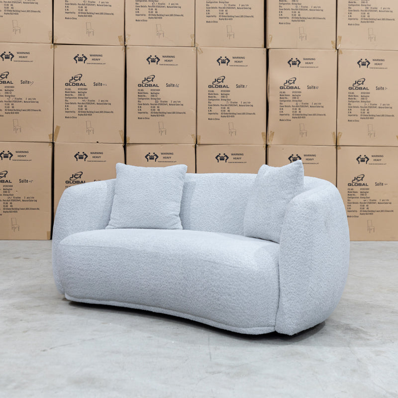 The Trenton Curved Boucle Two Seater - Light Grey available to purchase from Warehouse Furniture Clearance at our next sale event.
