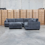 The Veloura Deep Seat Feather & Foam Corner Suite with Ottoman - Carbon available to purchase from Warehouse Furniture Clearance at our next sale event.