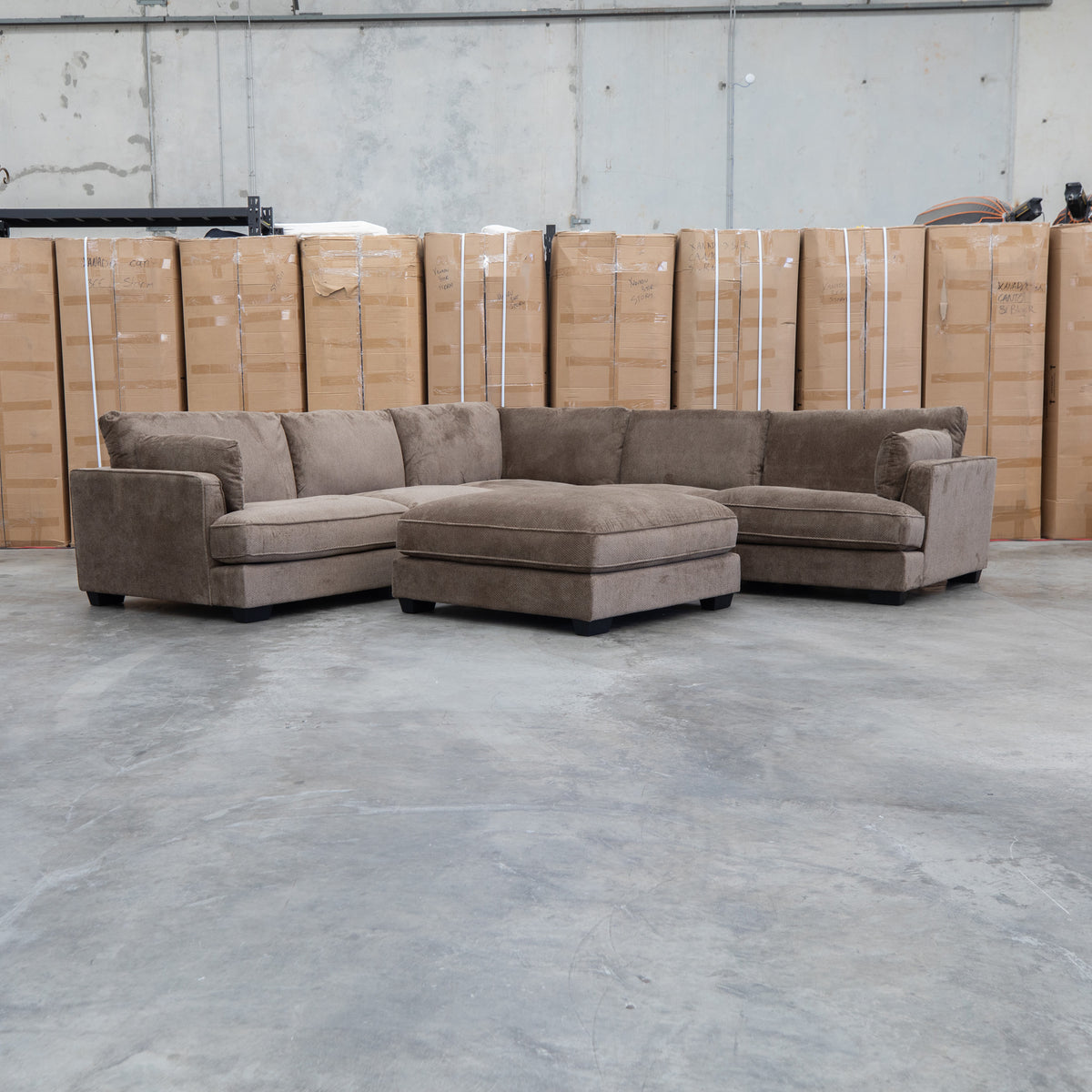 The Veloura Feather & Foam Corner Suite with Ottoman - Leeds Chocolate available to purchase from Warehouse Furniture Clearance at our next sale event.