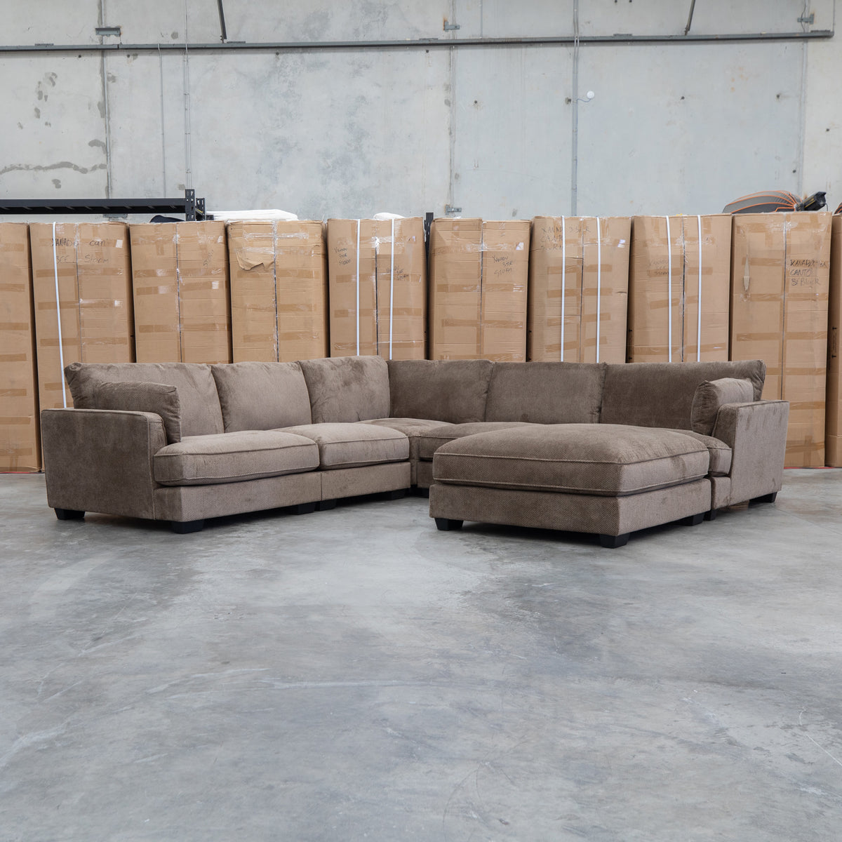 The Veloura Feather & Foam Corner Suite with Ottoman - Leeds Chocolate available to purchase from Warehouse Furniture Clearance at our next sale event.
