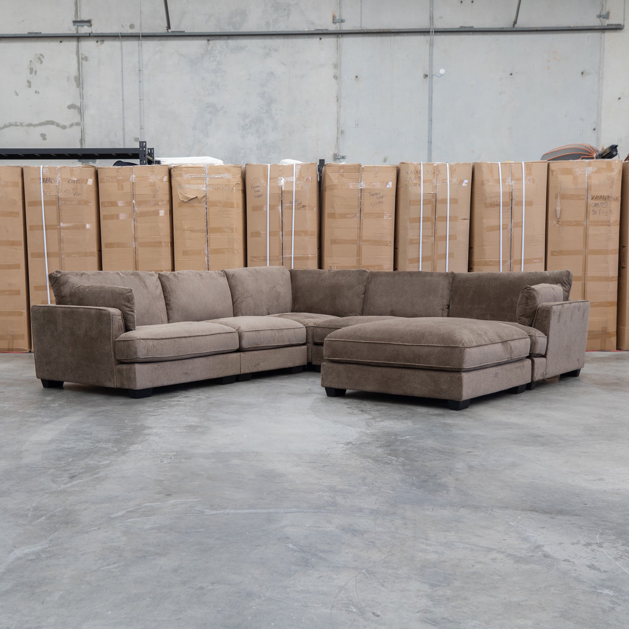 The Veloura Feather & Foam Corner Suite with Ottoman - Leeds Chocolate available to purchase from Warehouse Furniture Clearance at our next sale event.