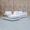 The Zenith Modular Reversible Chaise Lounge With Bookshelf - Oat White available to purchase from Warehouse Furniture Clearance at our next sale event.