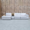 The Zenith Modular Reversible Chaise Lounge With Bookshelf - Oat White available to purchase from Warehouse Furniture Clearance at our next sale event.