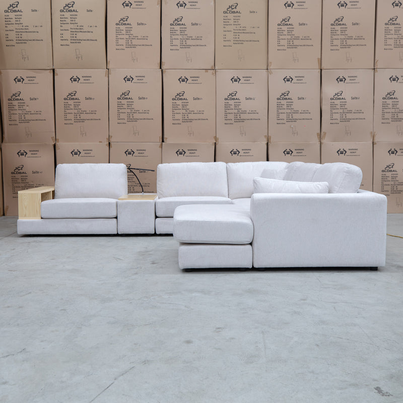 The Zenith Modular Reversible Corner Chaise Lounge With Bookshelf - Oat White available to purchase from Warehouse Furniture Clearance at our next sale event.