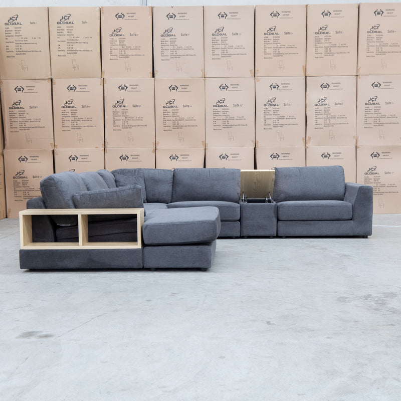 The Zenith Modular Reversible Corner Chaise Lounge With Bookshelf - Shadow available to purchase from Warehouse Furniture Clearance at our next sale event.