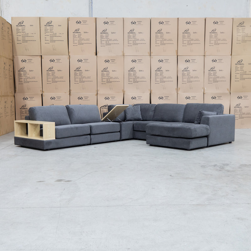 The Zenith Modular Reversible Corner Chaise Lounge With Bookshelf - Shadow available to purchase from Warehouse Furniture Clearance at our next sale event.