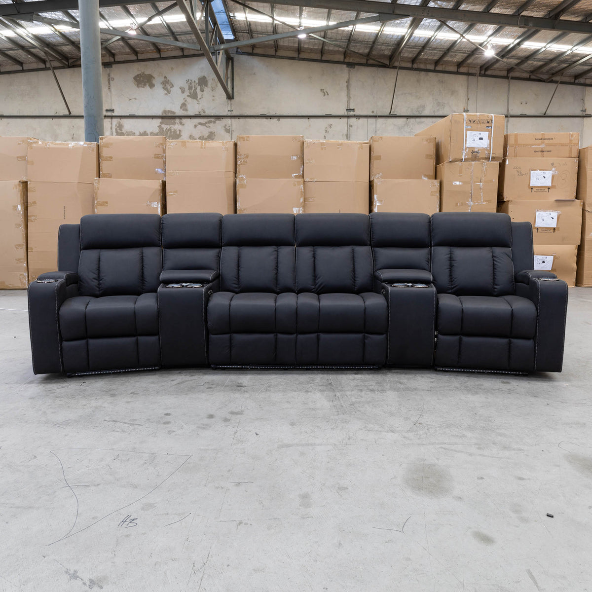 The Remi Four Seat Dual-Motor Electric Recliner Lounge - Jet - Floor Stock available to purchase from Warehouse Furniture Clearance at our next sale event.