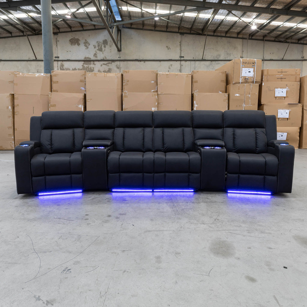 The Remi Four Seat Dual-Motor Electric Recliner Lounge - Jet - Floor Stock available to purchase from Warehouse Furniture Clearance at our next sale event.
