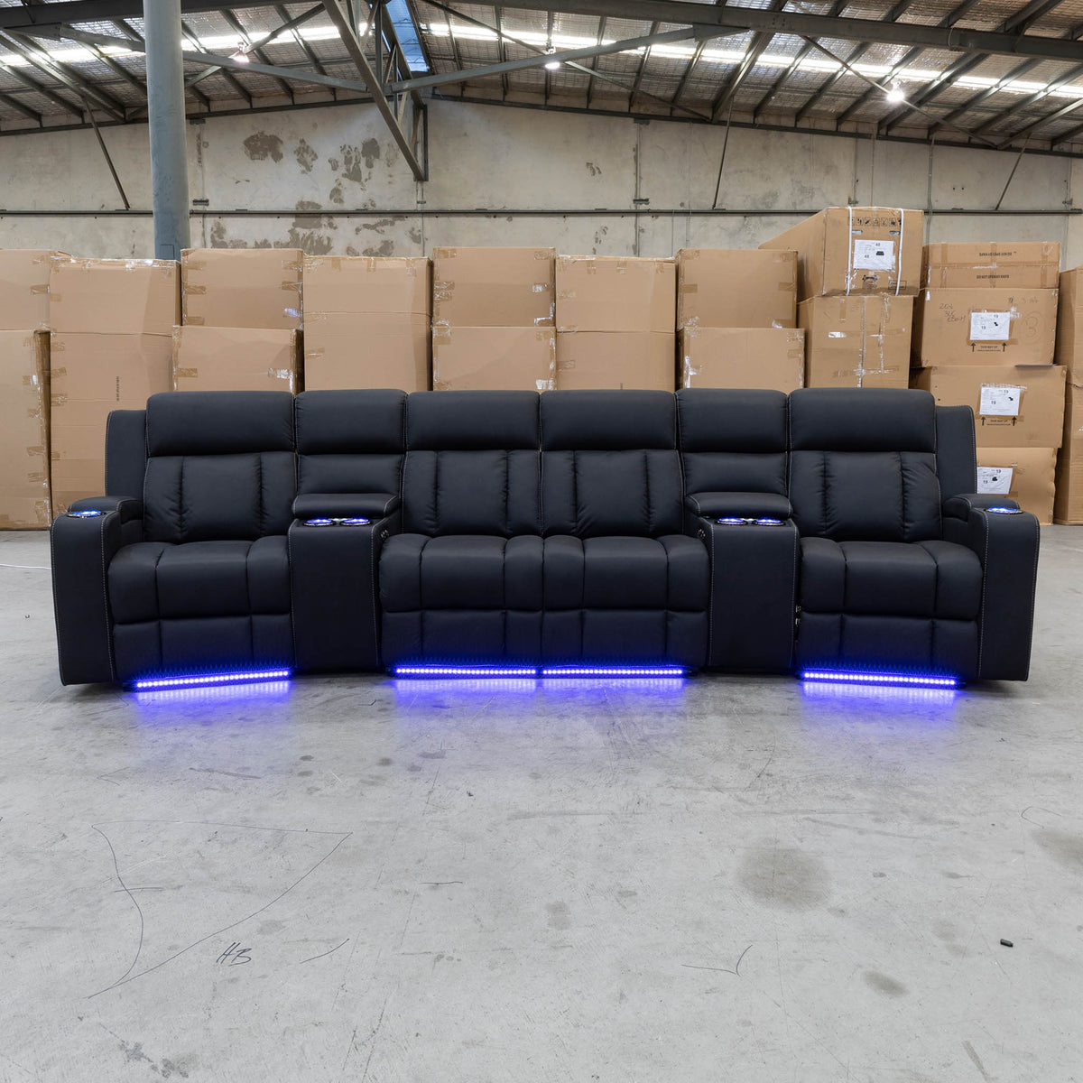 The Remi Four Seat Dual-Motor Electric Recliner Lounge - Jet - Floor Stock available to purchase from Warehouse Furniture Clearance at our next sale event.