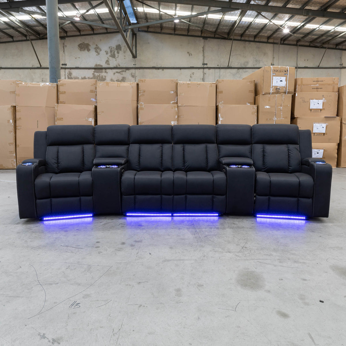 The Remi Four Seat Dual-Motor Electric Recliner Lounge - Jet - Floor Stock available to purchase from Warehouse Furniture Clearance at our next sale event.