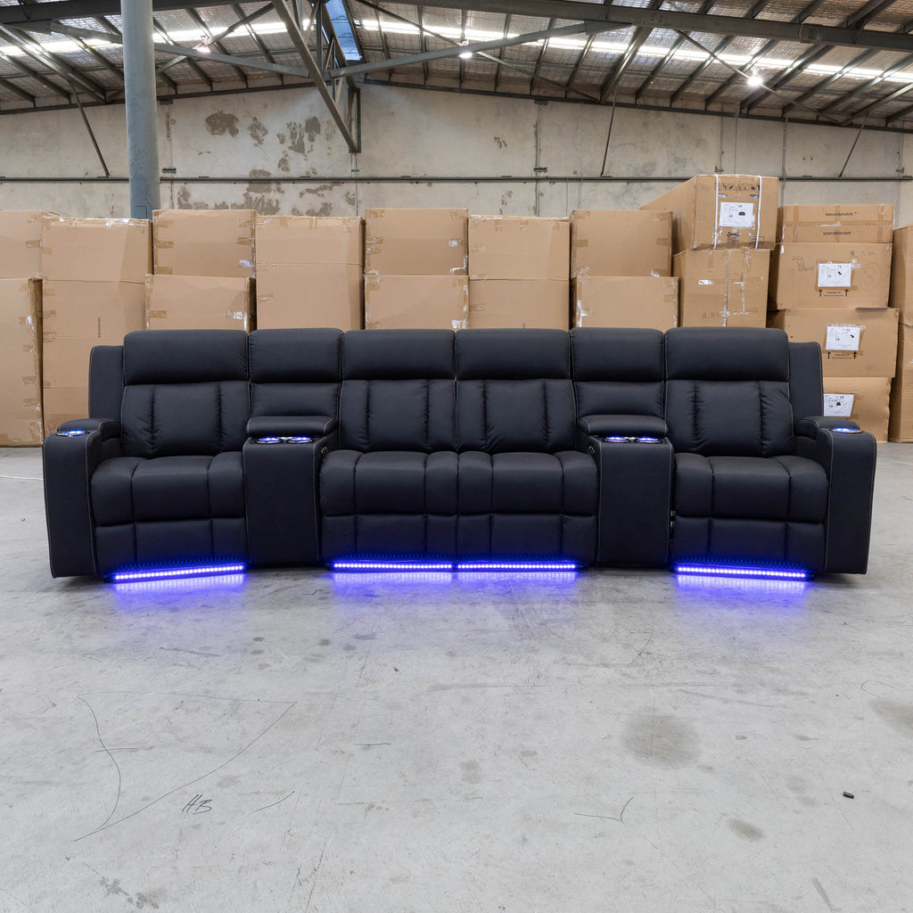 The Remi Four Seat Dual-Motor Electric Recliner Lounge - Jet - Floor Stock available to purchase from Warehouse Furniture Clearance at our next sale event.