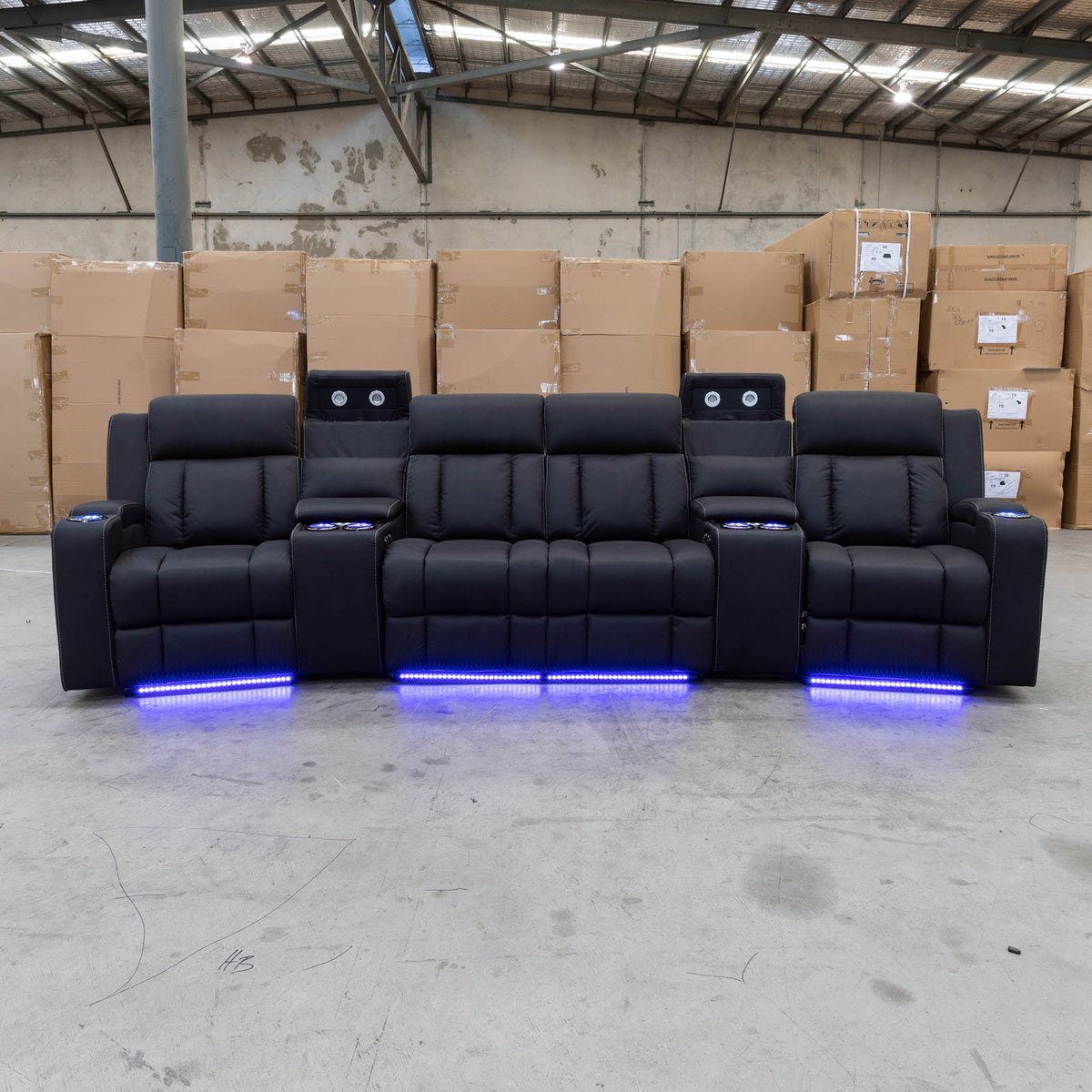 The Remi Four Seat Dual-Motor Electric Recliner Lounge - Jet - Floor Stock available to purchase from Warehouse Furniture Clearance at our next sale event.