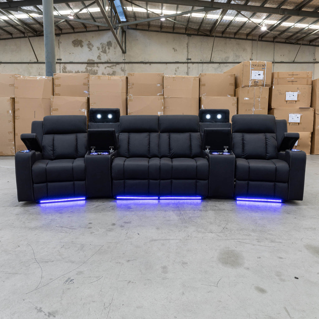 The Remi Four Seat Dual-Motor Electric Recliner Lounge - Jet - Floor Stock available to purchase from Warehouse Furniture Clearance at our next sale event.