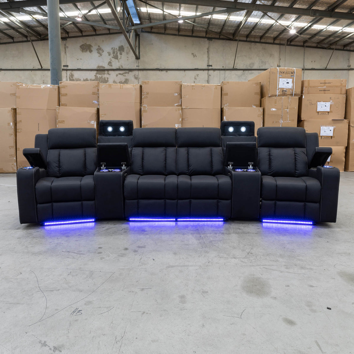 The Remi Four Seat Dual-Motor Electric Recliner Lounge - Jet - Floor Stock available to purchase from Warehouse Furniture Clearance at our next sale event.