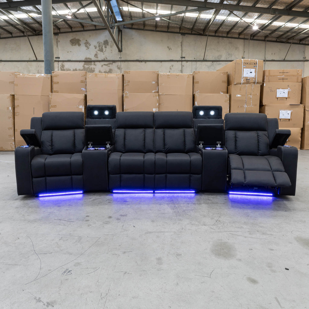 The Remi Four Seat Dual-Motor Electric Recliner Lounge - Jet - Floor Stock available to purchase from Warehouse Furniture Clearance at our next sale event.