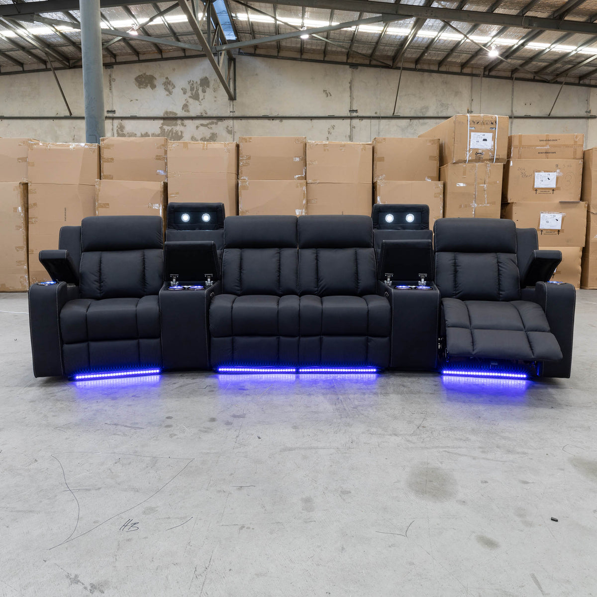 The Remi Four Seat Dual-Motor Electric Recliner Lounge - Jet - Floor Stock available to purchase from Warehouse Furniture Clearance at our next sale event.