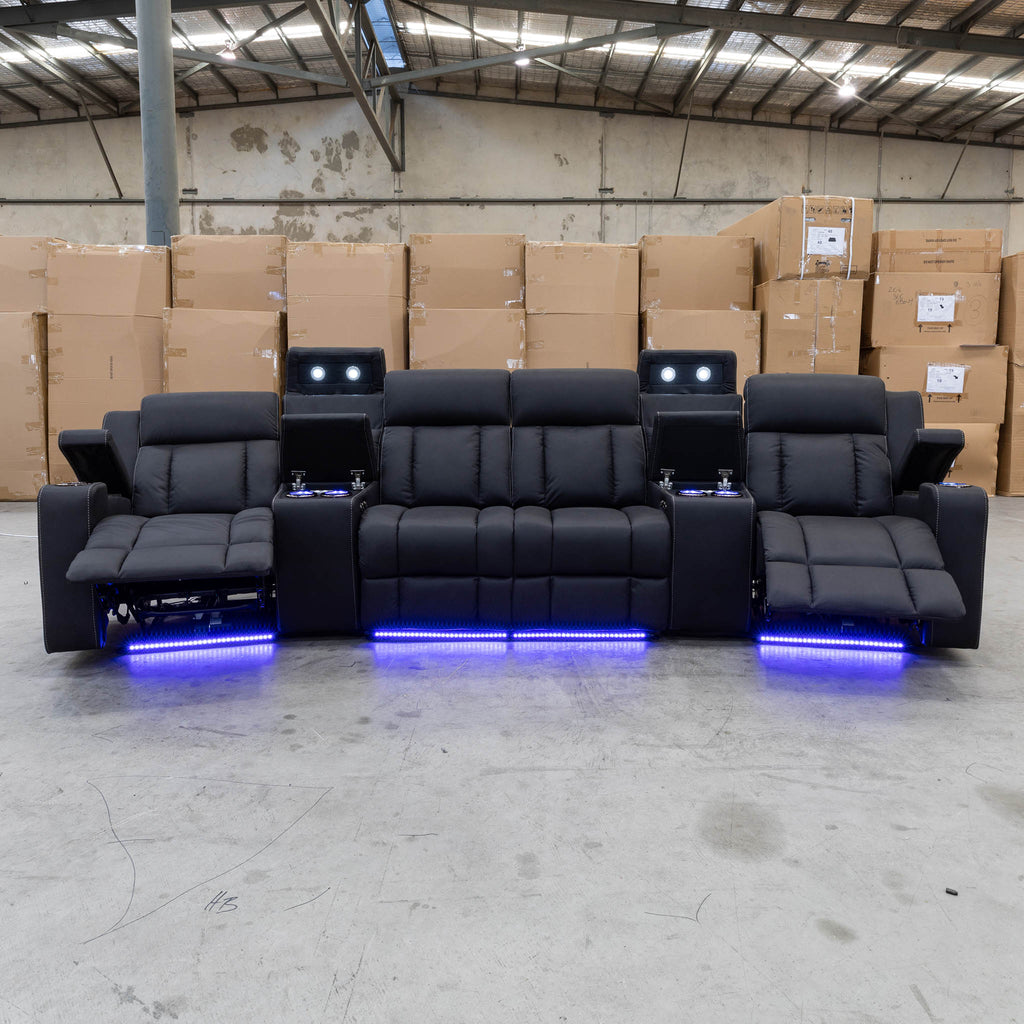 The Remi Four Seat Dual-Motor Electric Recliner Lounge - Jet - Floor Stock available to purchase from Warehouse Furniture Clearance at our next sale event.
