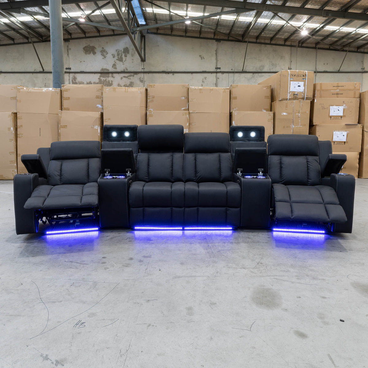 The Remi Four Seat Dual-Motor Electric Recliner Lounge - Jet - Floor Stock available to purchase from Warehouse Furniture Clearance at our next sale event.