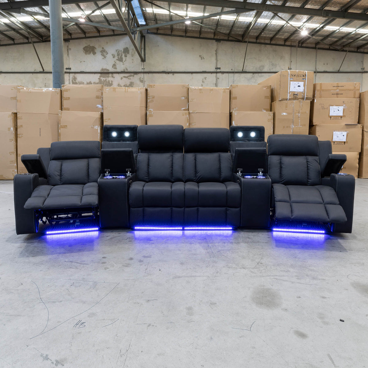 The Remi Four Seat Dual-Motor Electric Recliner Lounge - Jet - Floor Stock available to purchase from Warehouse Furniture Clearance at our next sale event.