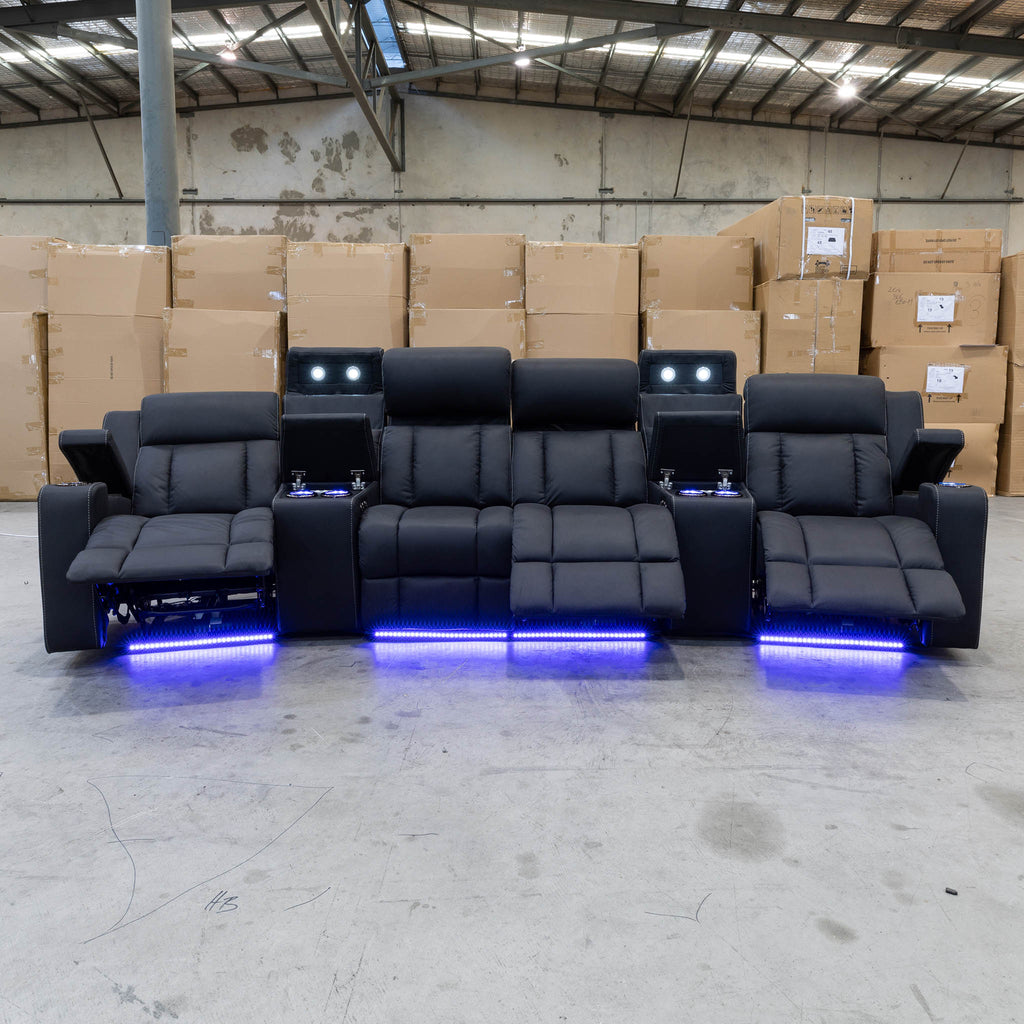 The Remi Four Seat Dual-Motor Electric Recliner Lounge - Jet - Floor Stock available to purchase from Warehouse Furniture Clearance at our next sale event.