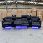 The Remi Four Seat Dual-Motor Electric Recliner Lounge - Jet - Floor Stock available to purchase from Warehouse Furniture Clearance at our next sale event.