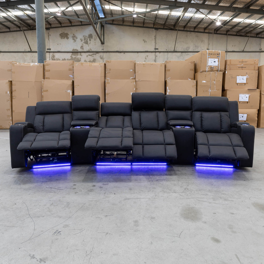 The Remi Four Seat Dual-Motor Electric Recliner Lounge - Jet - Floor Stock available to purchase from Warehouse Furniture Clearance at our next sale event.