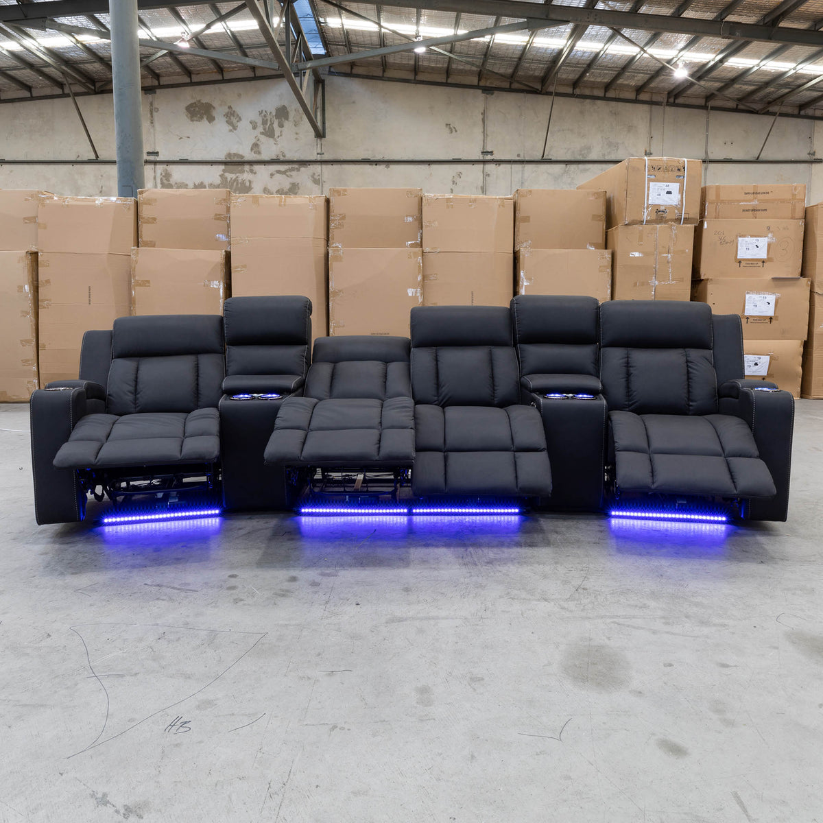 The Remi Four Seat Dual-Motor Electric Recliner Lounge - Jet - Floor Stock available to purchase from Warehouse Furniture Clearance at our next sale event.