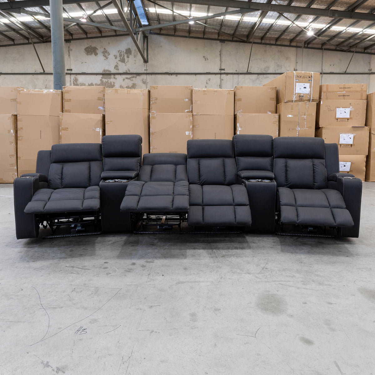 The Remi Four Seat Dual-Motor Electric Recliner Lounge - Jet - Floor Stock available to purchase from Warehouse Furniture Clearance at our next sale event.
