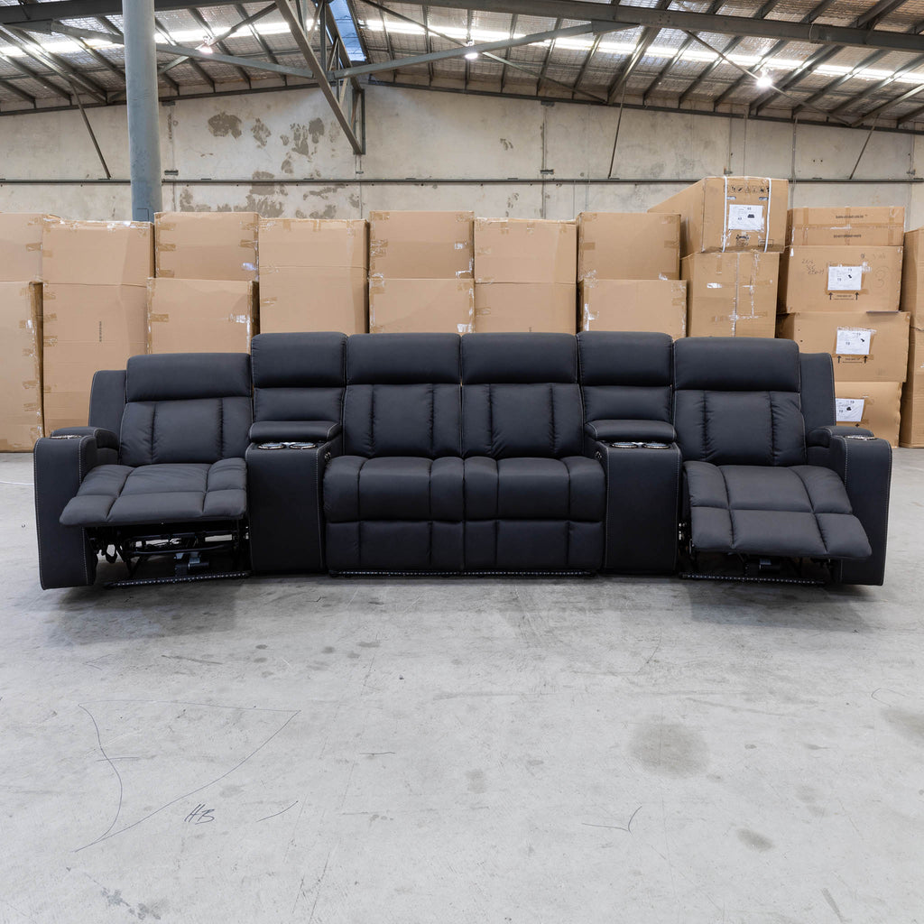 The Remi Four Seat Dual-Motor Electric Recliner Lounge - Jet - Floor Stock available to purchase from Warehouse Furniture Clearance at our next sale event.