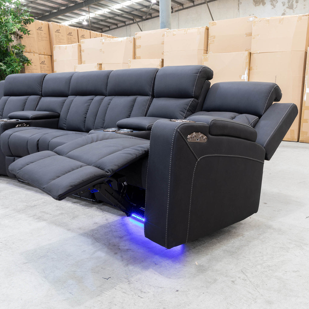 The Remi Four Seat Dual-Motor Electric Recliner Lounge - Jet - Floor Stock available to purchase from Warehouse Furniture Clearance at our next sale event.