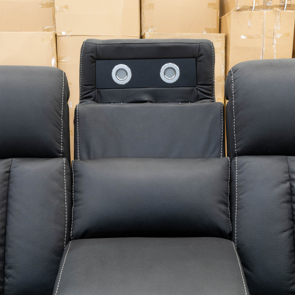The Remi Four Seat Dual-Motor Electric Recliner Lounge - Jet - Floor Stock available to purchase from Warehouse Furniture Clearance at our next sale event.