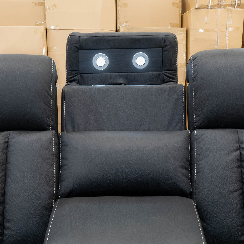 The Remi Four Seat Dual-Motor Electric Recliner Lounge - Jet - Floor Stock available to purchase from Warehouse Furniture Clearance at our next sale event.