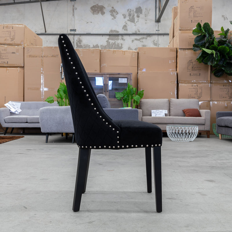 The Sienna Quilted Velvet Dining Chair - Onyx available to purchase from Warehouse Furniture Clearance at our next sale event.